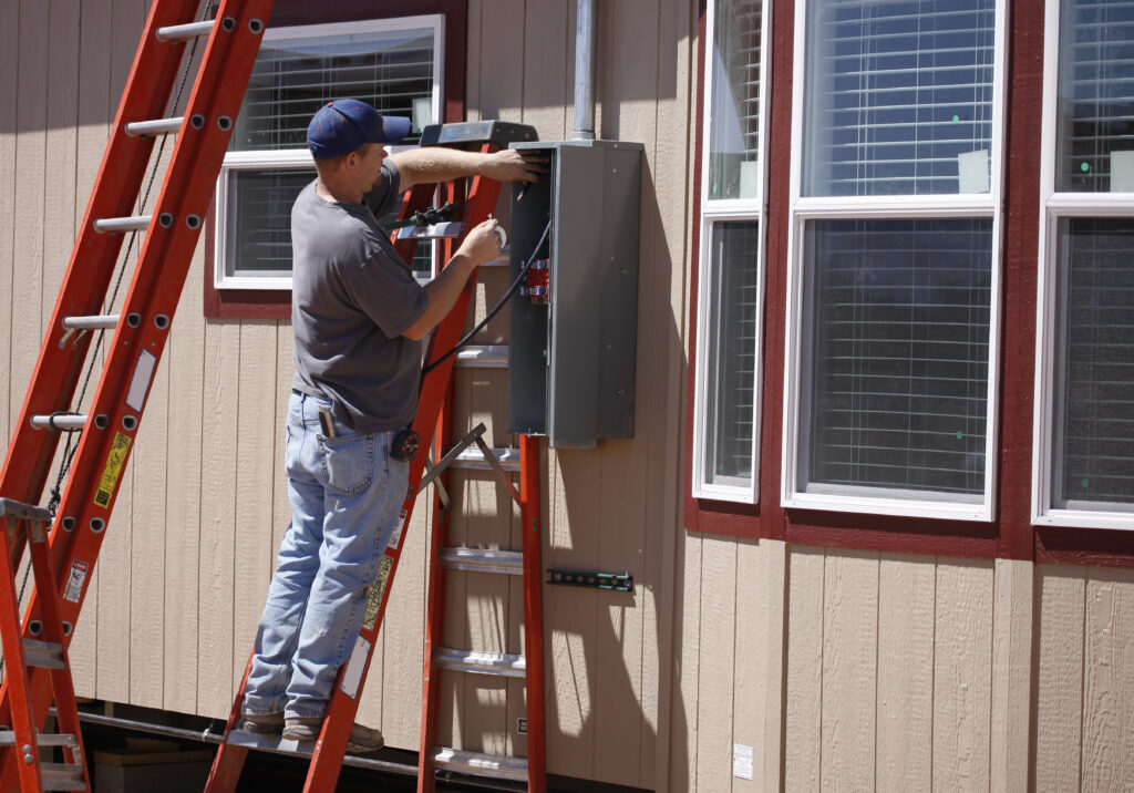 Electrician working on a new service for a manufactured home.