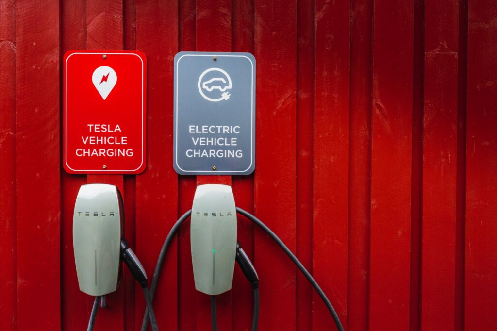 Tesla electric chargers on traditional red wooden house, rorbuer in the small fishing village of Nusfjord, Lofoten islands, Norway. Nusfjord, Norway - August 26 2019.